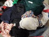 a pile of clothes in a basket on the floor