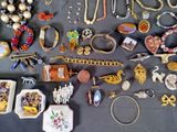 a lot of jewelry that is laying out on the table