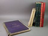 several old books are stacked on top of each other on a table