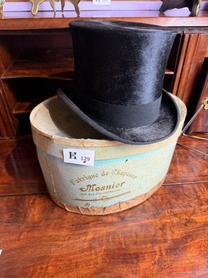 a black top hat sitting on top of a wooden box