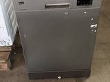 an image of a silver dishwasher sitting in a warehouse