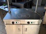 a kitchen with a stove and a counter with a number 13 on it