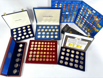 many different types of coins in a display case
