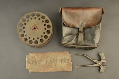 an old fishing reel and other items on the table
