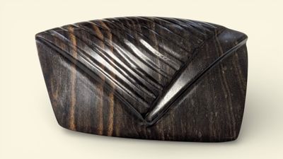 wooden sculpture of a square shaped object on a white surface