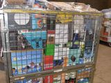 a metal cage filled with boxes of food in a warehouse
