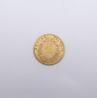 a close up of a gold coin on a white surface