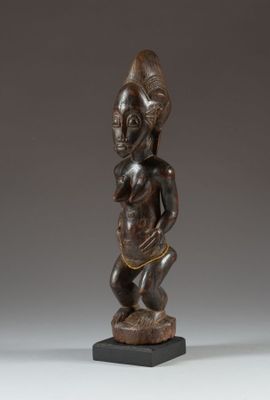 a wooden statue of a woman holding a baby