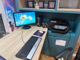 a desk with a computer and a printer on it
