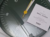 a clock that is sitting on top of a pile of papers