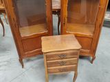 a small table with a mirror on top of it and a cabinet with a drawer underneath it