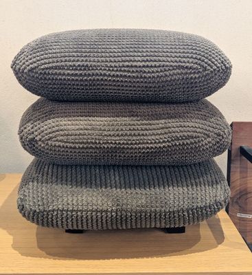 three pillows stacked on top of each other on top of a table