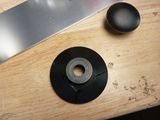 a knife on a table next to a black object