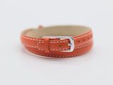 an orange leather bracelet with a silver buckle on a white background
