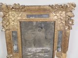 a picture of a mirror with a gold frame on it