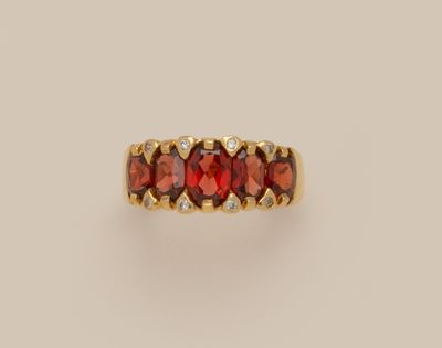 une bague en or sertie de grenats et de diamants
