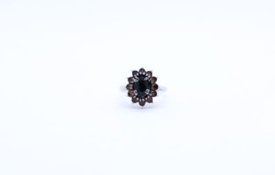 a close up of a ring on a white surface with a white background