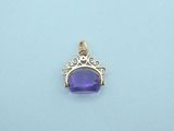 an amethorate and diamond pendant on a blue background