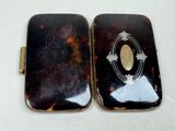 two black and gold cases sitting on a white surface
