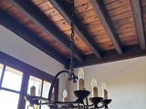 a chandelier hanging from the ceiling in a dining room