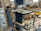 an image of a workshop with a table sawing machine