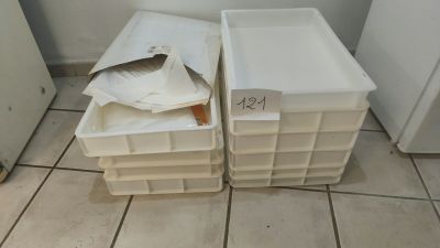 two plastic containers sitting next to each other on the floor