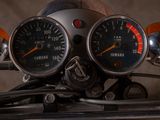 two speedometers on the handlebars of a motorcycle