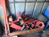 a pile of old red machinery in a garage