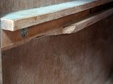 a close up of a wooden shelf on a wall