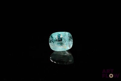 an image of a blue diamond sitting on top of a black surface