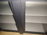two open shelves in the corner of a room