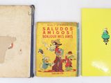 three books are lined up on a white surface, one is yellow and the other is red