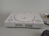a game console and a game controller on a table