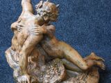statue of a man and a woman on a rock on a blue carpet
