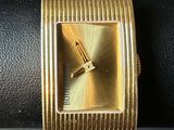 an image of a close up of a gold watch on a wrist