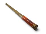 an old telescope with a wooden handle on a white surface