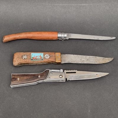 two knives and a knife sharper are on a table