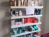 a shelf that has many different types of hair products on it