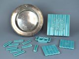 a silver plate and a silver tray with blue tiles