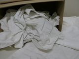 a box full of white clothing on a bed