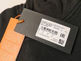 a label on the back of a black shirt
