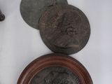 some coins and a knife sitting on a table next to each other