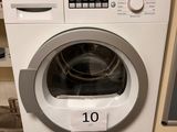 a washing machine that is sitting in the kitchen