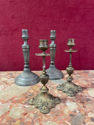 three candles are sitting on a table with a red wall in the background