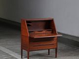 a small wooden desk with a drawer on top of it