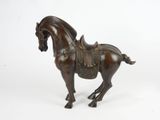 statue of a horse with a saddle on its back on a white background