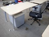 a desk with a chair and a computer on it