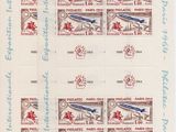 four stamps with different designs on them on a sheet of paper