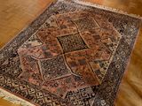 a rug on the floor in a room with a table and chairs