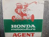 a sign that says honda motorcycle club agent on it
